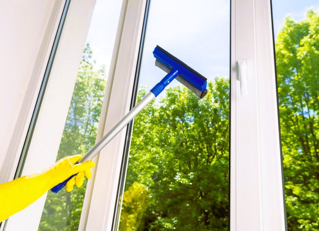Cleaning a window with a mop